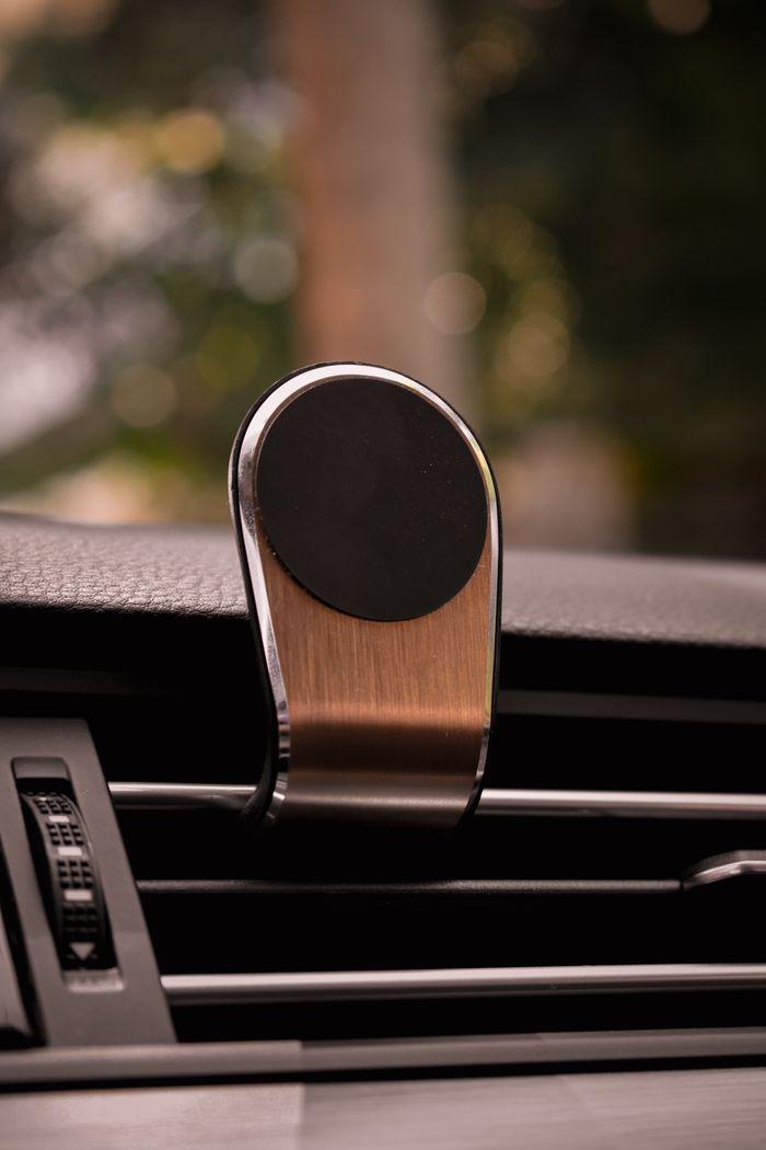 client-satisfaction-img Close-up of a metallic magnetic phone holder on car air vent.